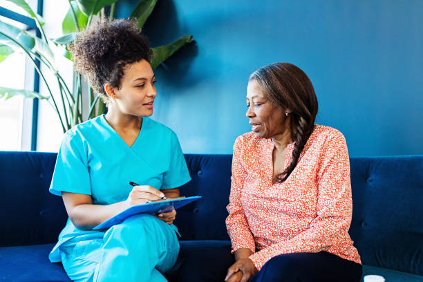 Caregiver supporting elderly woman at home